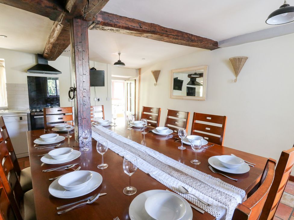 A dining room with a large table and chairs at Penarth in Cregrina near Builth Wells