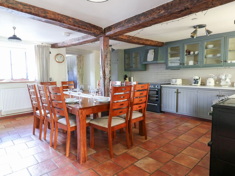 A kitchen with a dining table and chairs at Penarth in Cregrina near Builth Wells