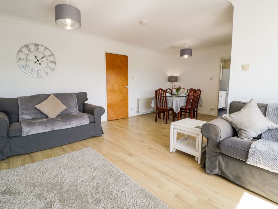 A living room with a sofa and dining table at Trem Y Foel Penrhyndeudraeth