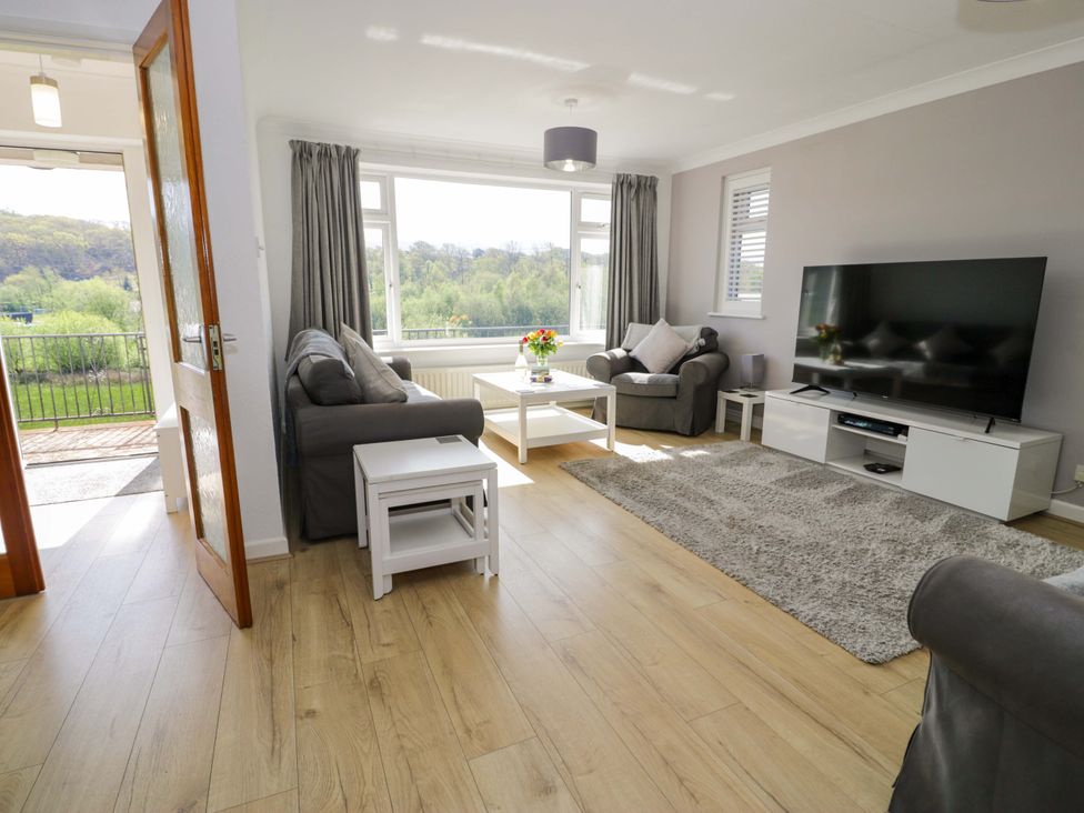 A living room with a sofa and television at Trem Y Foel in Penrhyndeudraeth