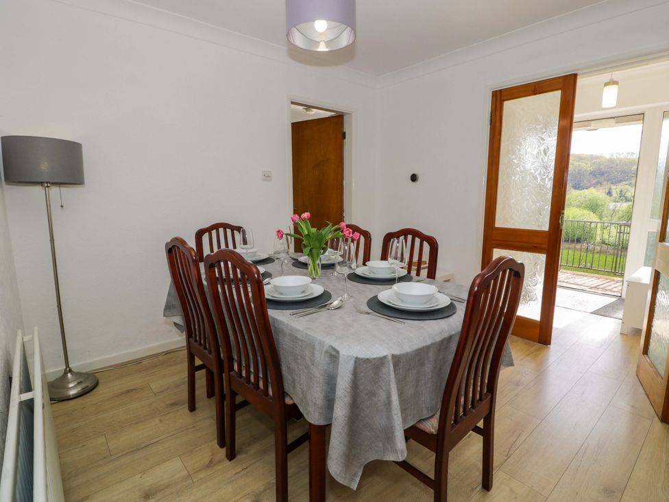 A dining room with a table set for dinner at Trem Y Foel in Penrhyndeudraeth