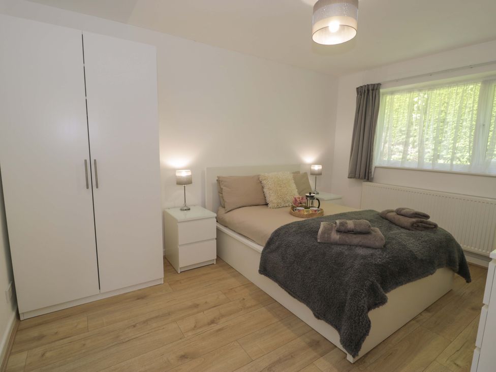 A bedroom with a bed and wardrobe at Trem Y Foel in Penrhyndeudraeth