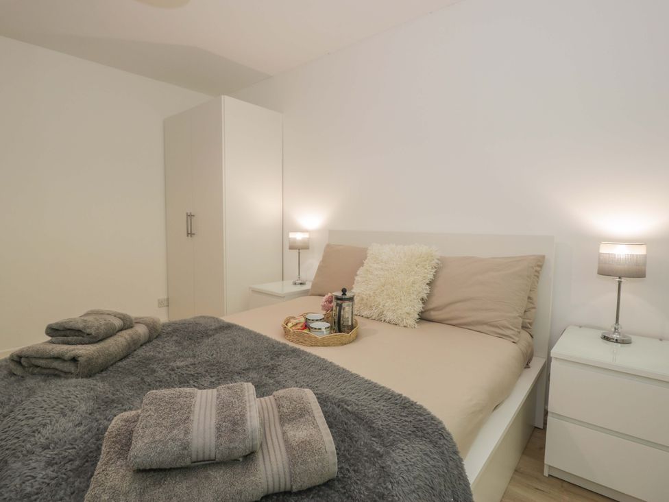 A bedroom with a bed and nightstands at Trem Y Foel in Penrhyndeudraeth