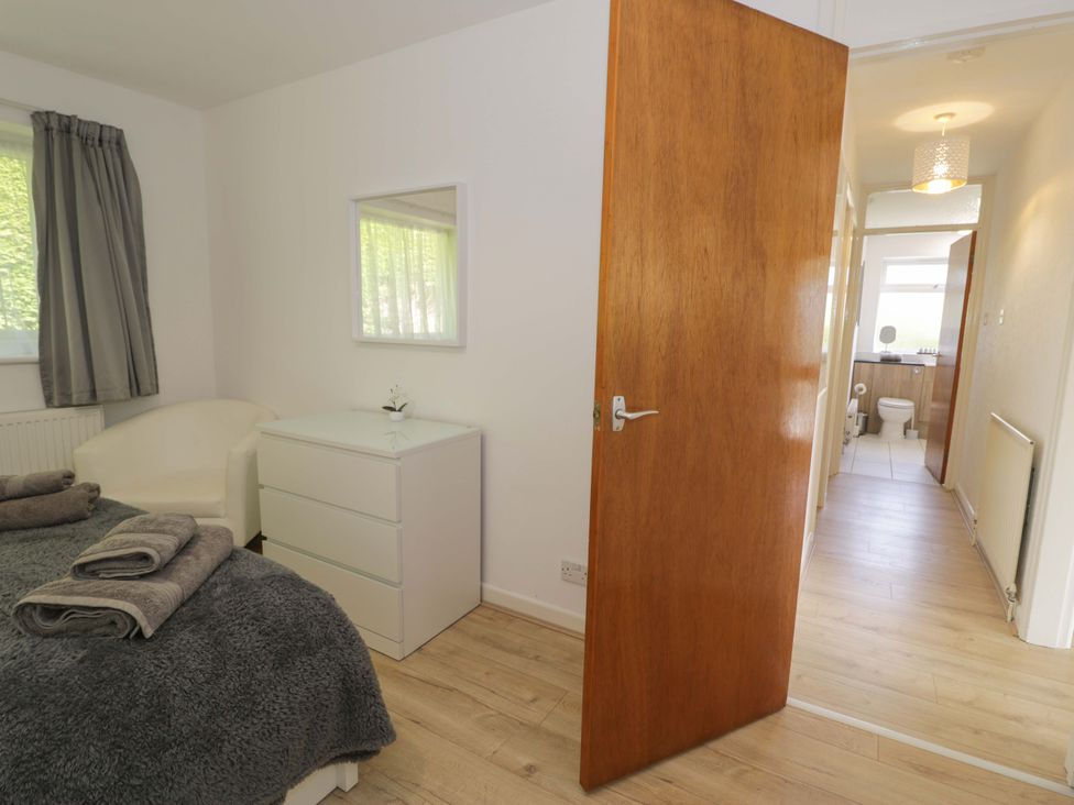 A bedroom with a bed and dresser at Trem Y Foel in Penrhyndeudraeth
