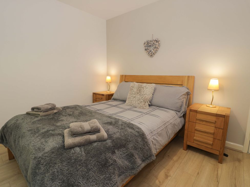 A bedroom with a bed and bedside tables at Trem Y Foel in Penrhyndeudraeth