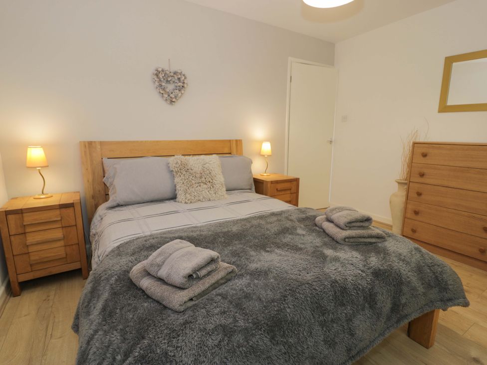 A bedroom with a bed and nightstands at Trem Y Foel in Penrhyndeudraeth