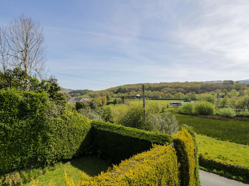 A view of trees and hedges with a road at Trem Y Foel in Penrhyndeudraeth