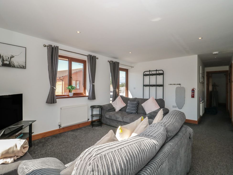 A living room with a sofa and television at Bluebell Lodge, Meadow view lodges Brean