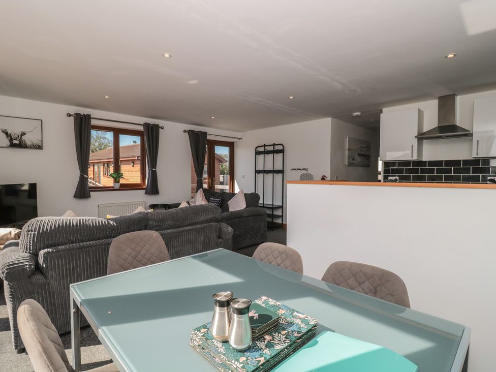 A living room with a sofa and television at Bluebell Lodge, Meadow view lodges in Brean