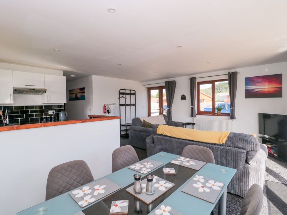 A living room with a dining area and sofa at Delphine Lodge, Meadow View Lodges, Brean