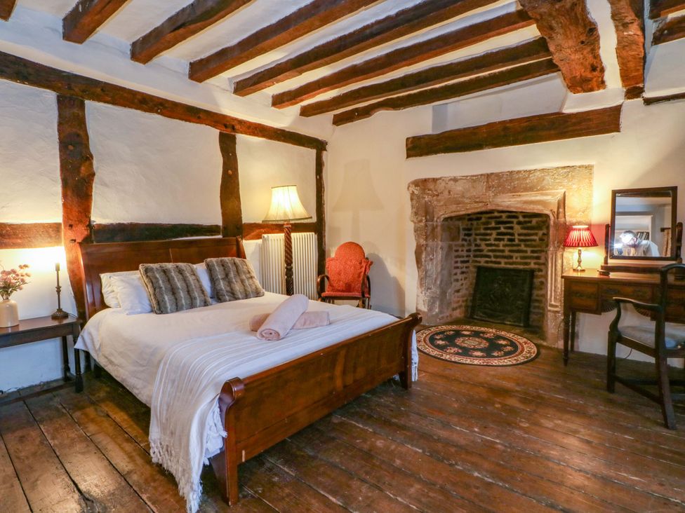 A bedroom with a bed and lamp at Y Fferm in Pontblyddyn