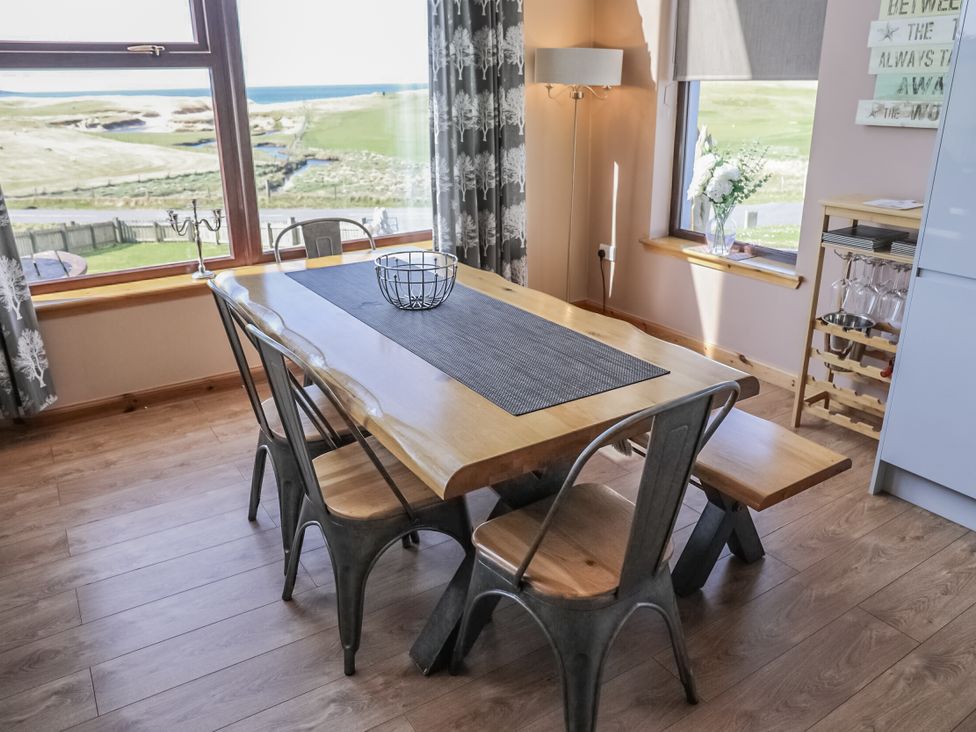 A dining room with a table and chairs at Otter Cottage Scarista near Leverburgh