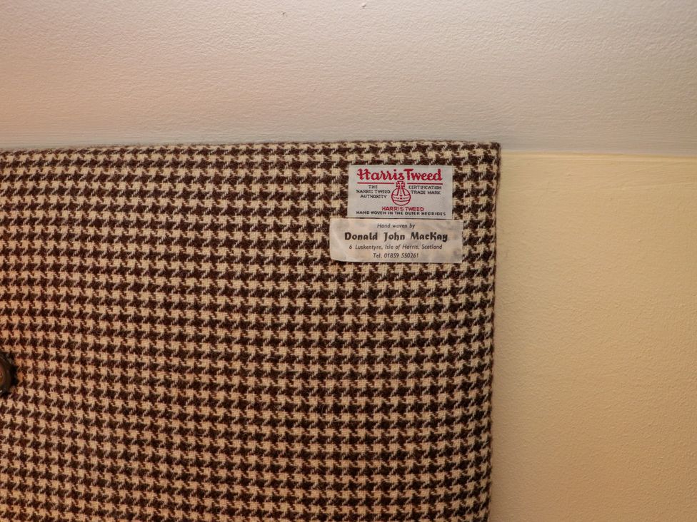 Harris Tweed fabric with label information by Donald John MacKay at Otter Cottage Scarista near Leverburgh