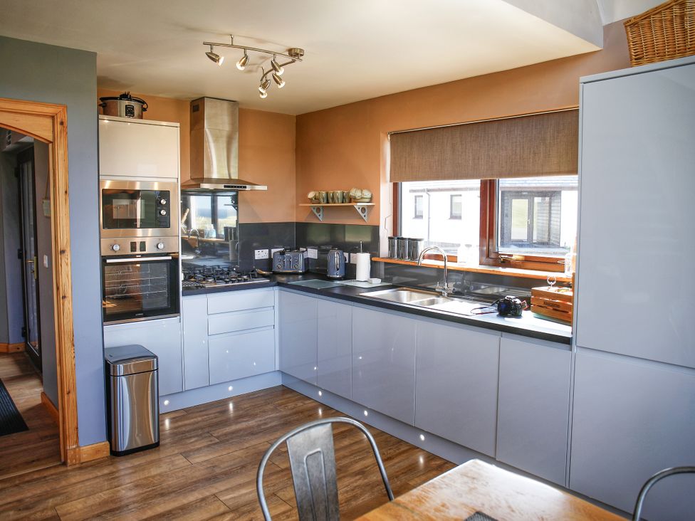 A kitchen with modern appliances at Corncrake Cottage in Leverburgh