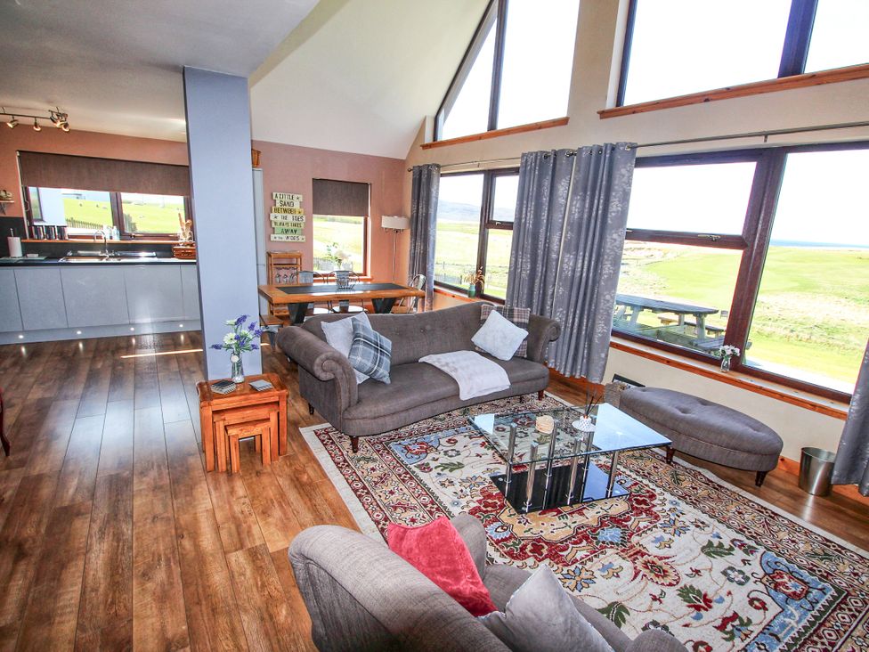 A living room with a coffee table and sofa at Corncrake Cottage in Leverburgh