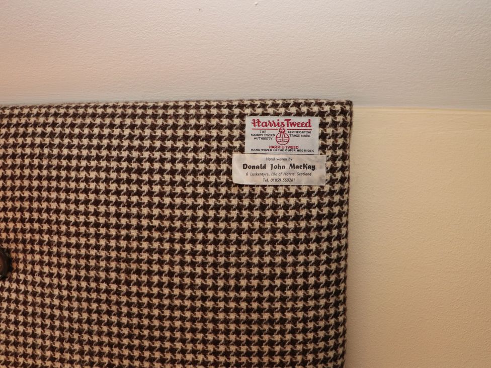 Harris Tweed label on patterned fabric made by Donald John MacKay