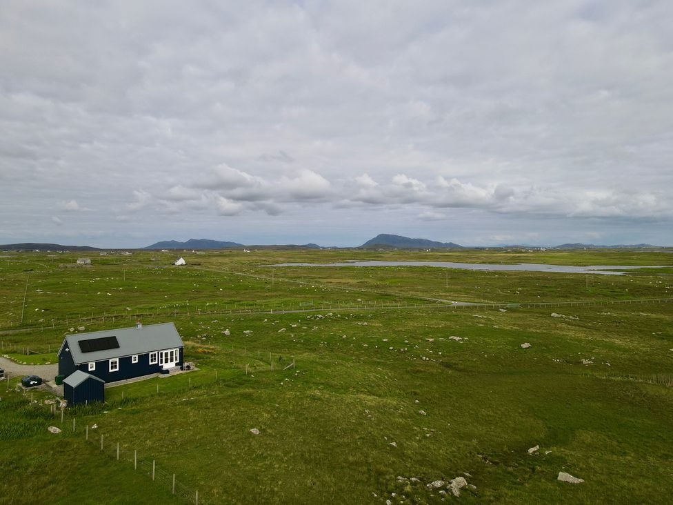 A house with solar panels near a field at Taigh Gorm Baleshare near Balivanich