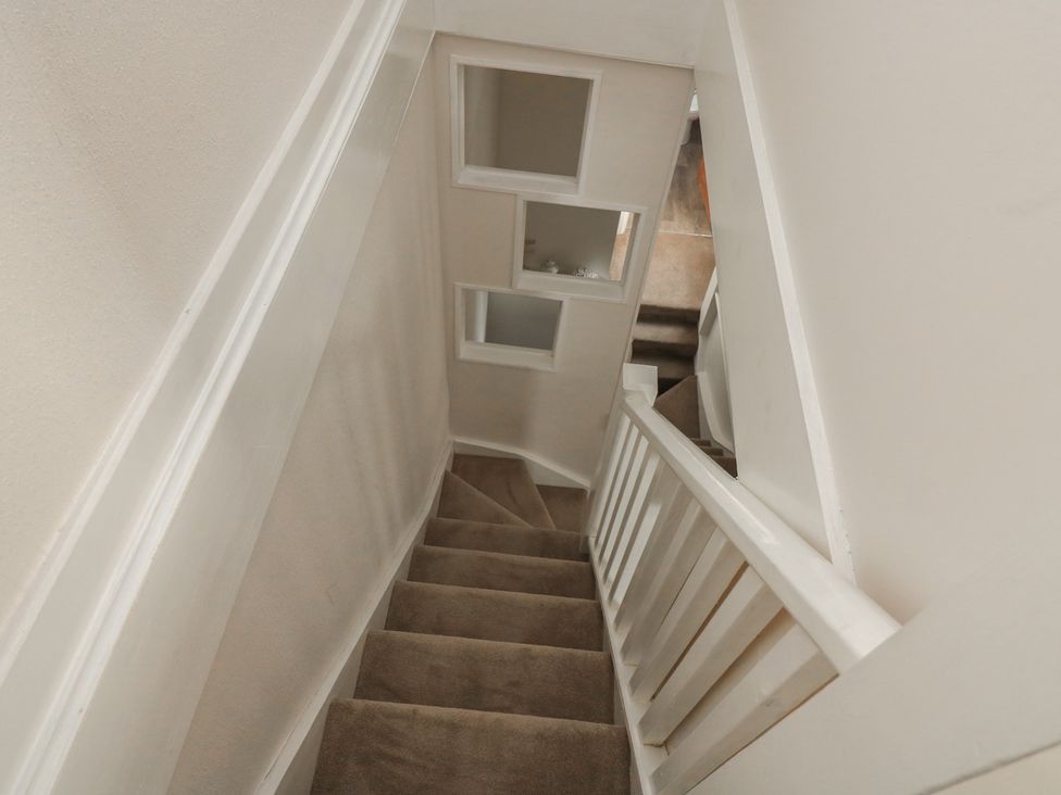 A staircase with windows and carpet at Crew House in Dartmouth