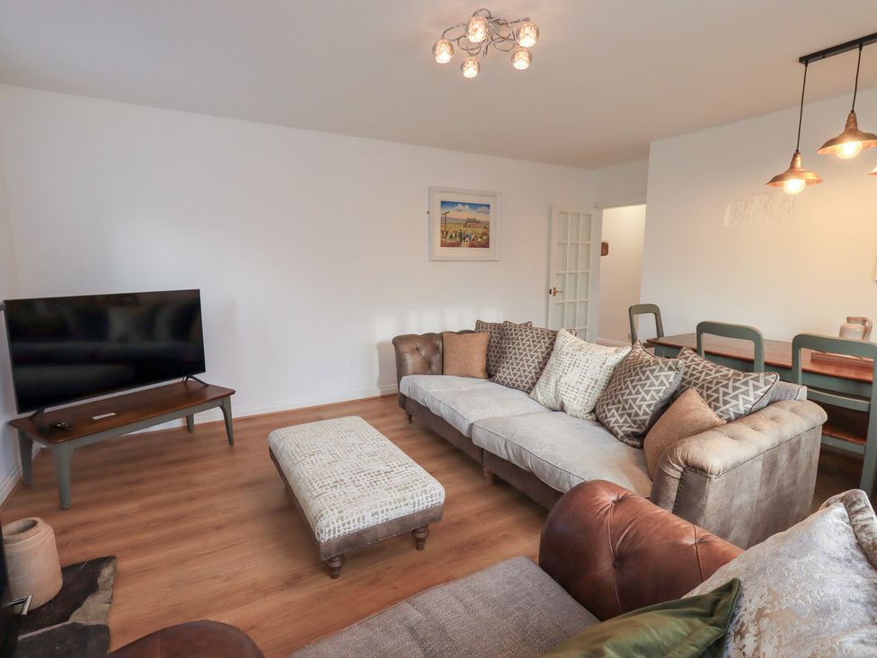 A living room with a sofa and television at Glen Lea in Giggleswick, Settle