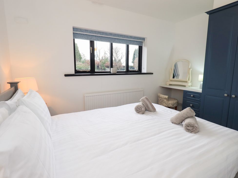 A bedroom with a bed and a dresser at Glen Lea in Giggleswick, Settle