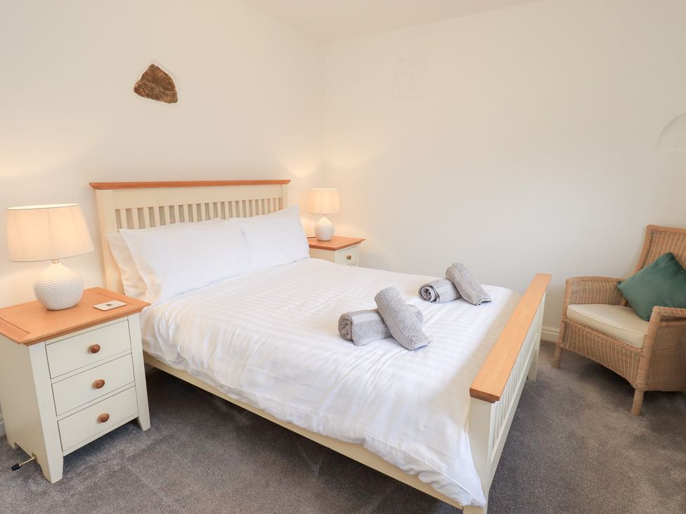A bedroom with a bed and nightstand at Glen Lea, Giggleswick, Settle