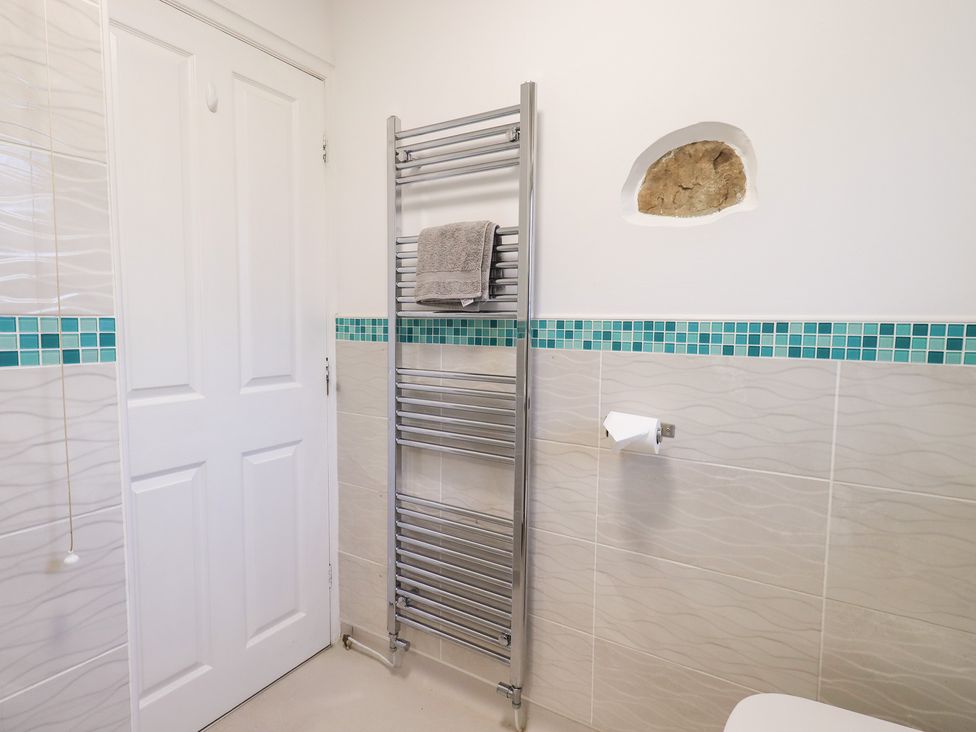 A bathroom with a towel rack and toilet at Glen Lea in Giggleswick, Settle