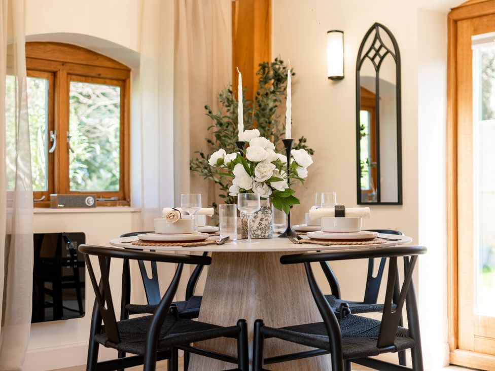 A dining room with a table and chairs at Dovecote in East Langdon near St Margaret's At Cliffe
