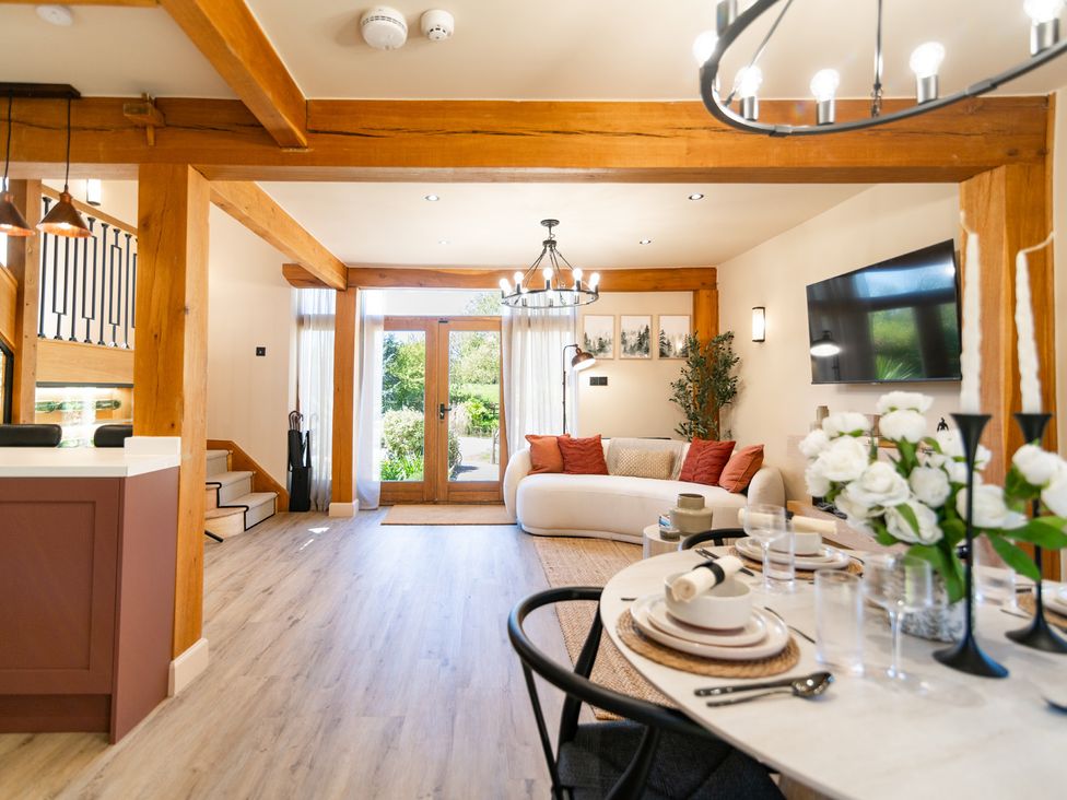 A living room with a sofa and dining table at Dovecote in East Langdon near St Margaret's At Cliffe