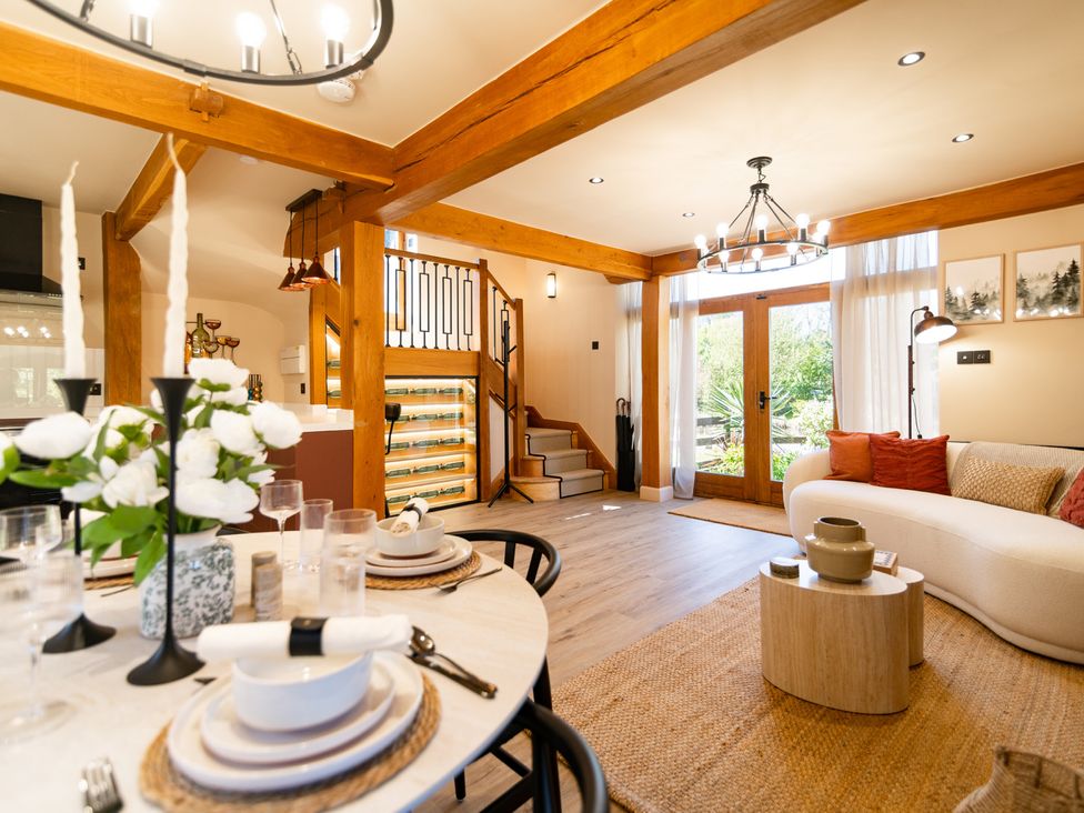 A living room with a dining area and sofa at Dovecote East Langdon near St Margaret's At Cliffe