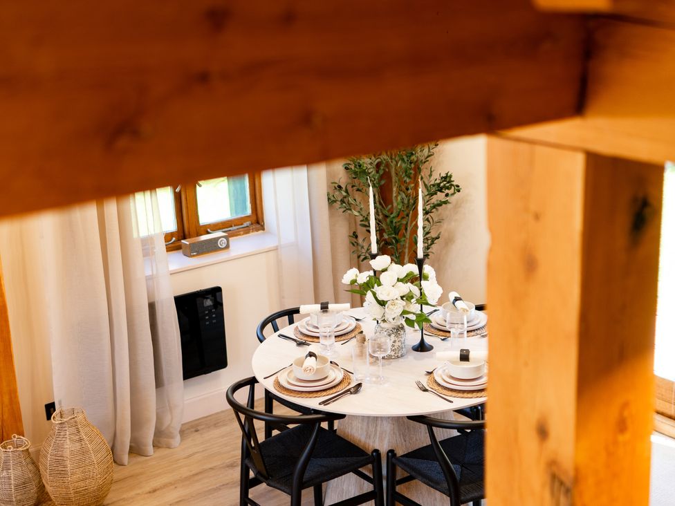 A dining room with a table set for dinner at Dovecote, East Langdon near St Margaret's At Cliffe