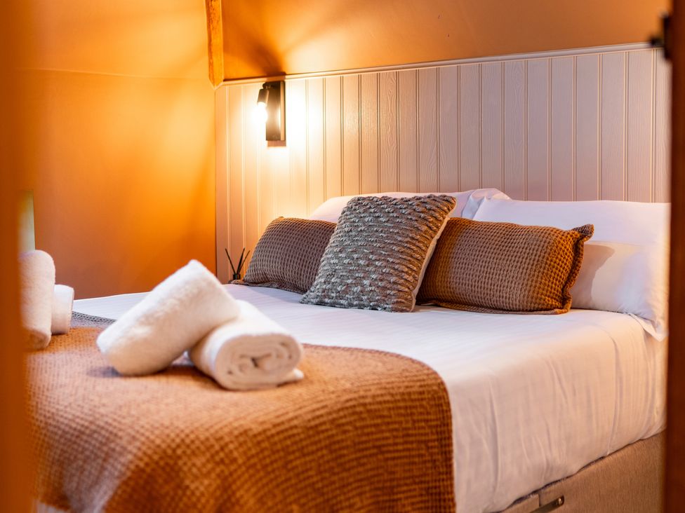 A bedroom with a bed and pillows at Dovecote East Langdon near St Margaret's At Cliffe