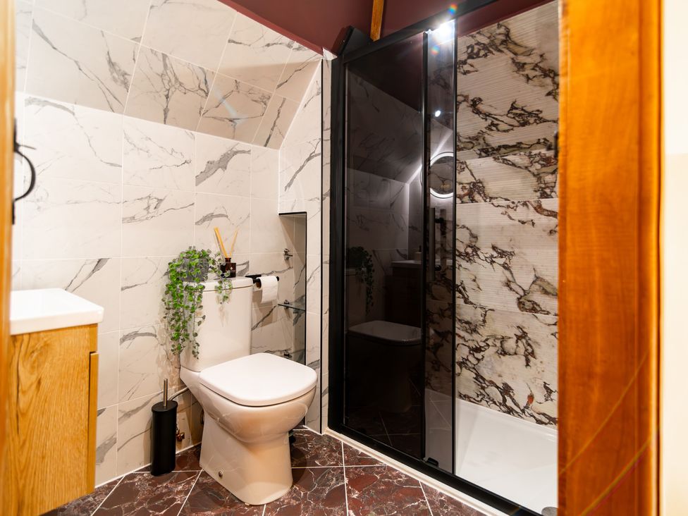 A bathroom featuring a shower, toilet, and sink at Dovecote in East Langdon near St Margaret's At Cliffe