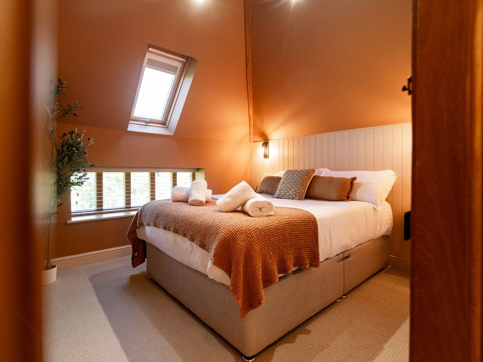 A bedroom with a bed and window at Dovecote East Langdon near St Margaret's At Cliffe