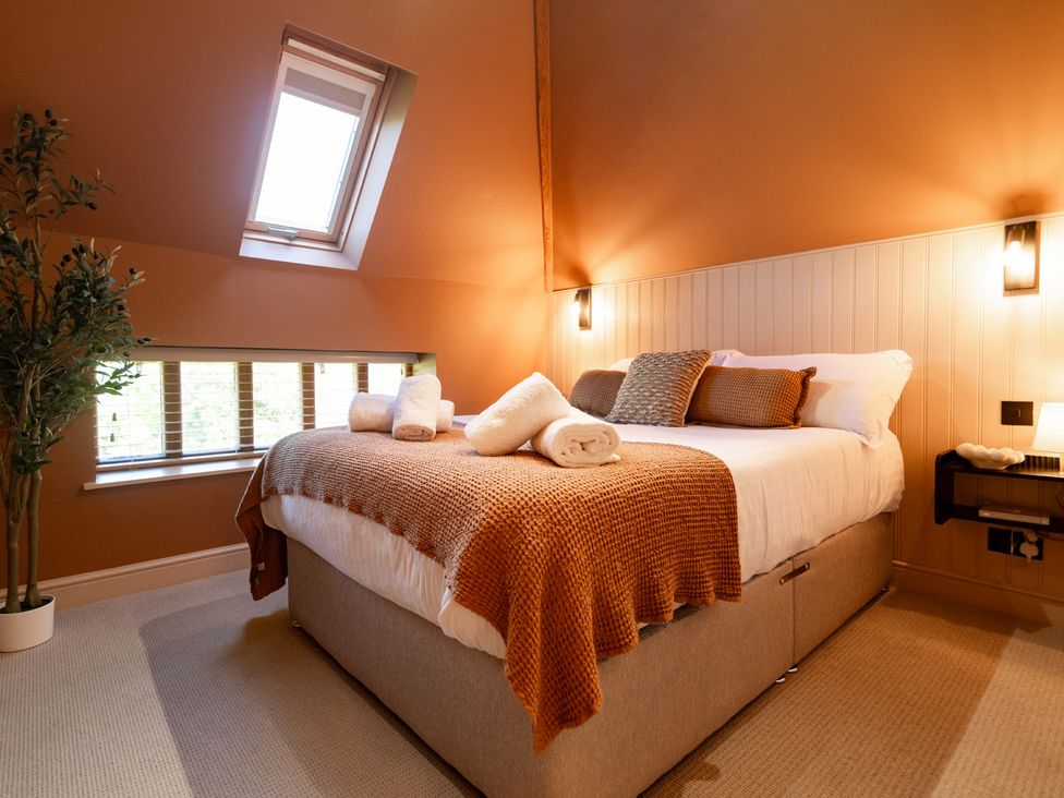 A bedroom with a bed and pillows at Dovecote in East Langdon near St Margaret's At Cliffe