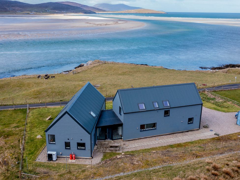 A house with a driveway near water at Taigh Rona Luskentyre Isle Of Harris