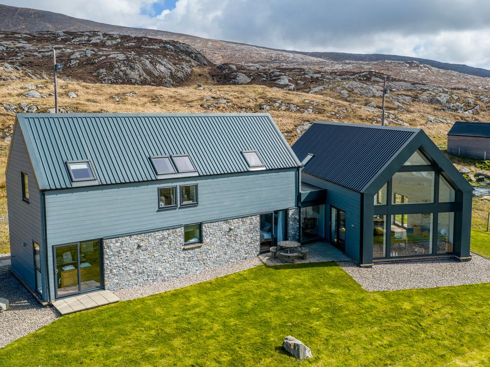 An outdoor view of a house with stone and metal features at Taigh Rona in Luskentyre Isle Of Harris