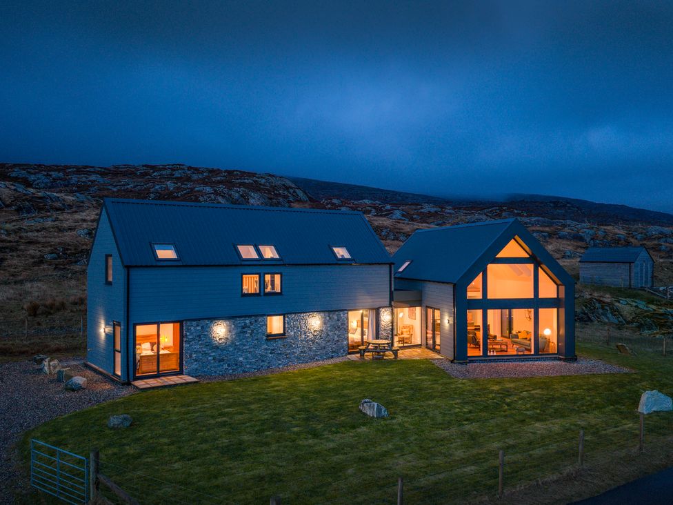 A house with large windows and grass area at Taigh Rona in Luskentyre Isle Of Harris