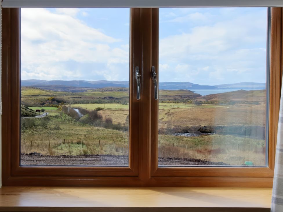 A view from a window showing a landscape at Falls Cottage in Uig