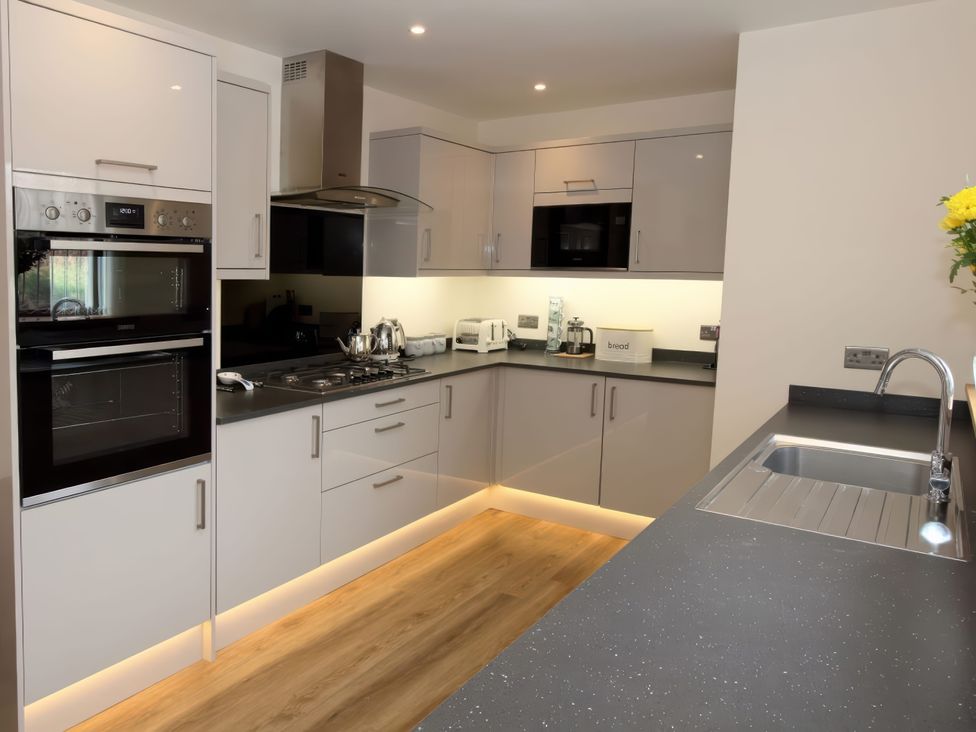 A kitchen with modern appliances and workspace at Falls Cottage Uig