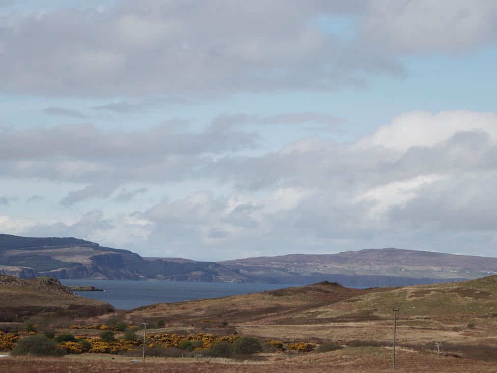 A view of the sea and mountains at Falls Cottage in Uig