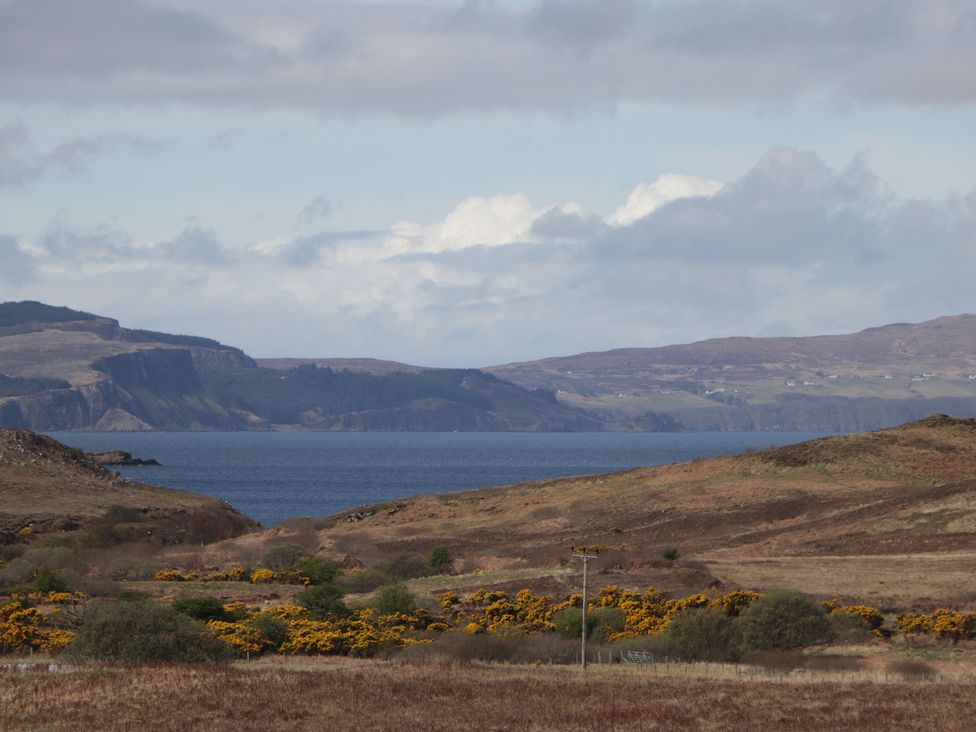 A view of hills and water at Falls Cottage in Uig