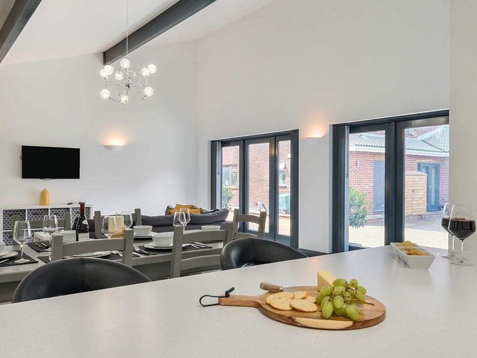 A dining room with a table and chairs at The Cottage in Wimborne Minster