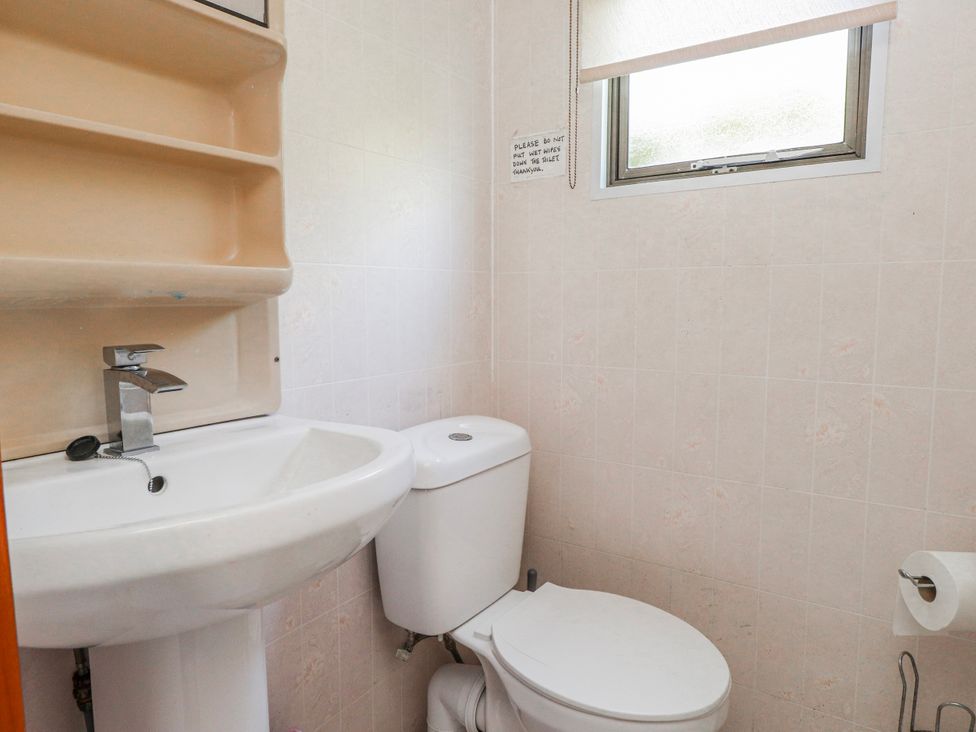 A bathroom with a sink and toilet at Fron Dderw Caravan Llanfairynghornwy near Llanfechell
