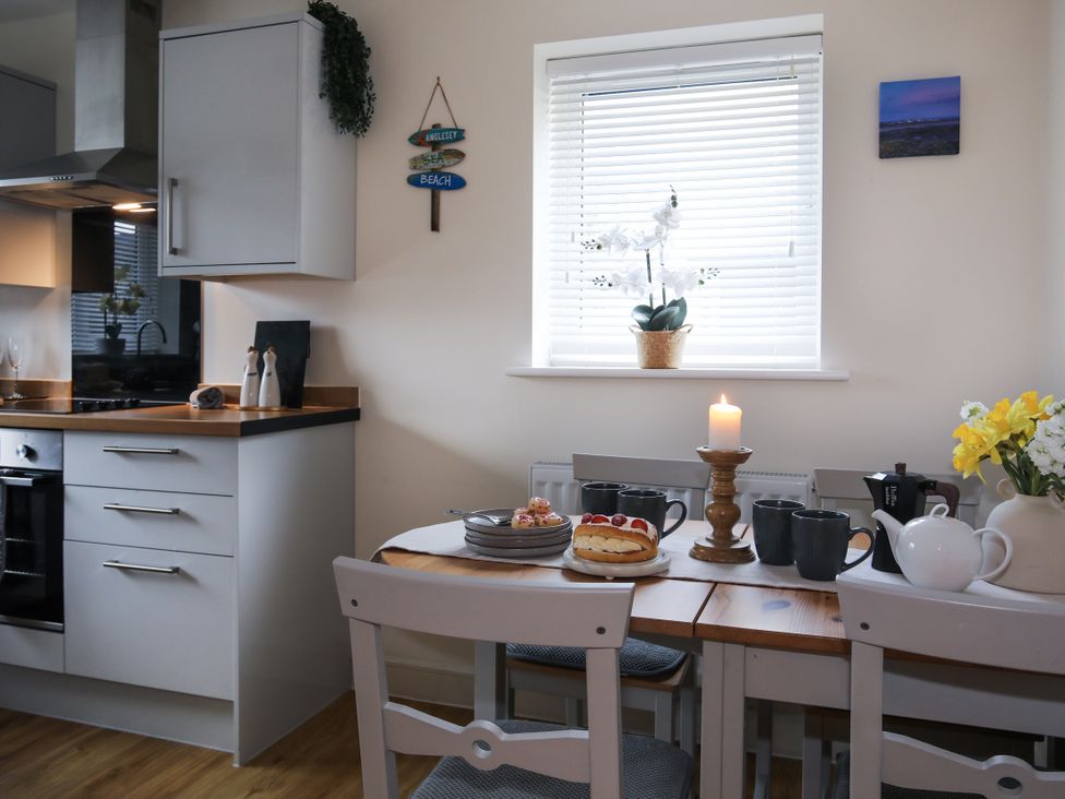 A kitchen with a table set for tea at Apartment 3 in Trearddur Bay