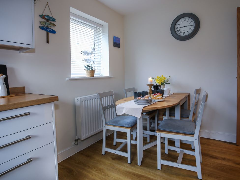 A dining room with a table and chairs at Apartment 3 in Trearddur Bay