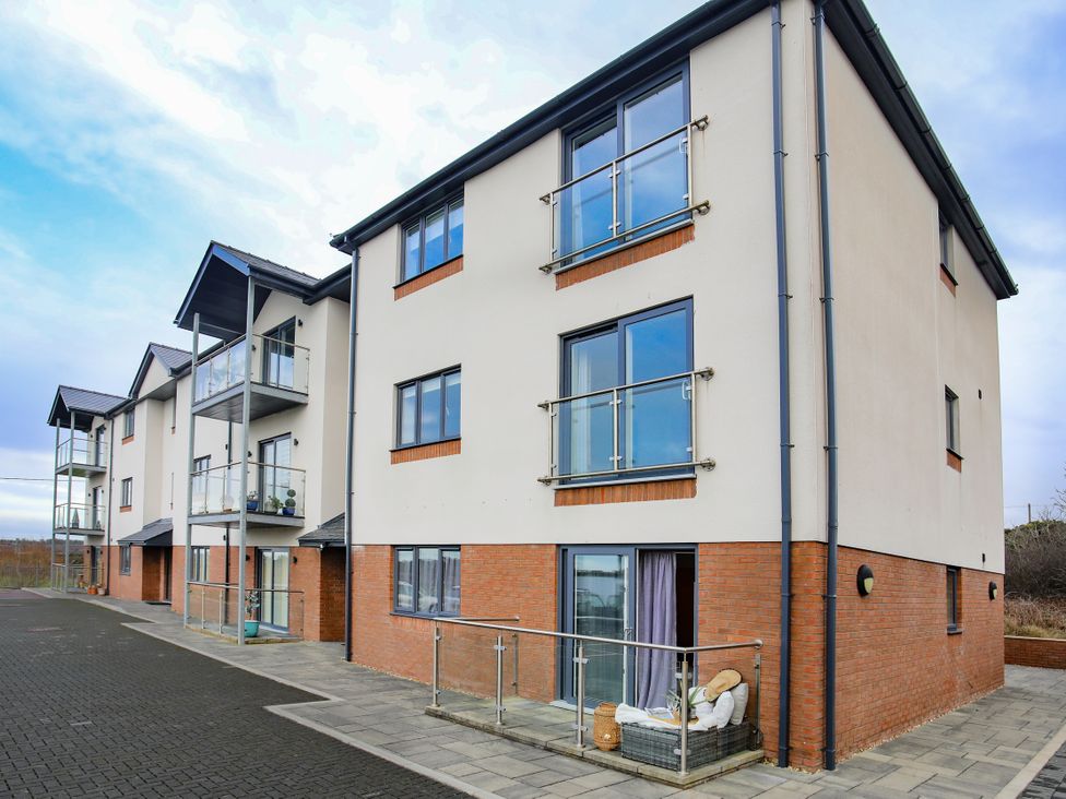An apartment building with balconies at Apartment 3 in Trearddur Bay