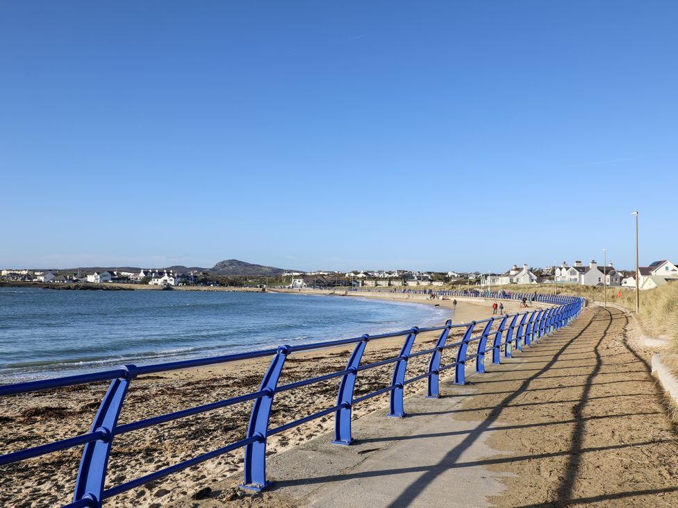 A path along the beach with houses in the background at Apartment 3 Trearddur Bay