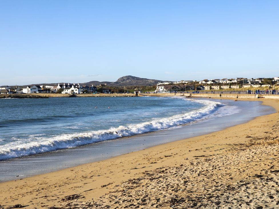 A beach with sand and water at Apartment 3 in Trearddur Bay