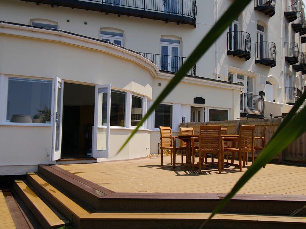 An outdoor dining area with a table and chairs at 11 Cove View Apartments in Ilfracombe