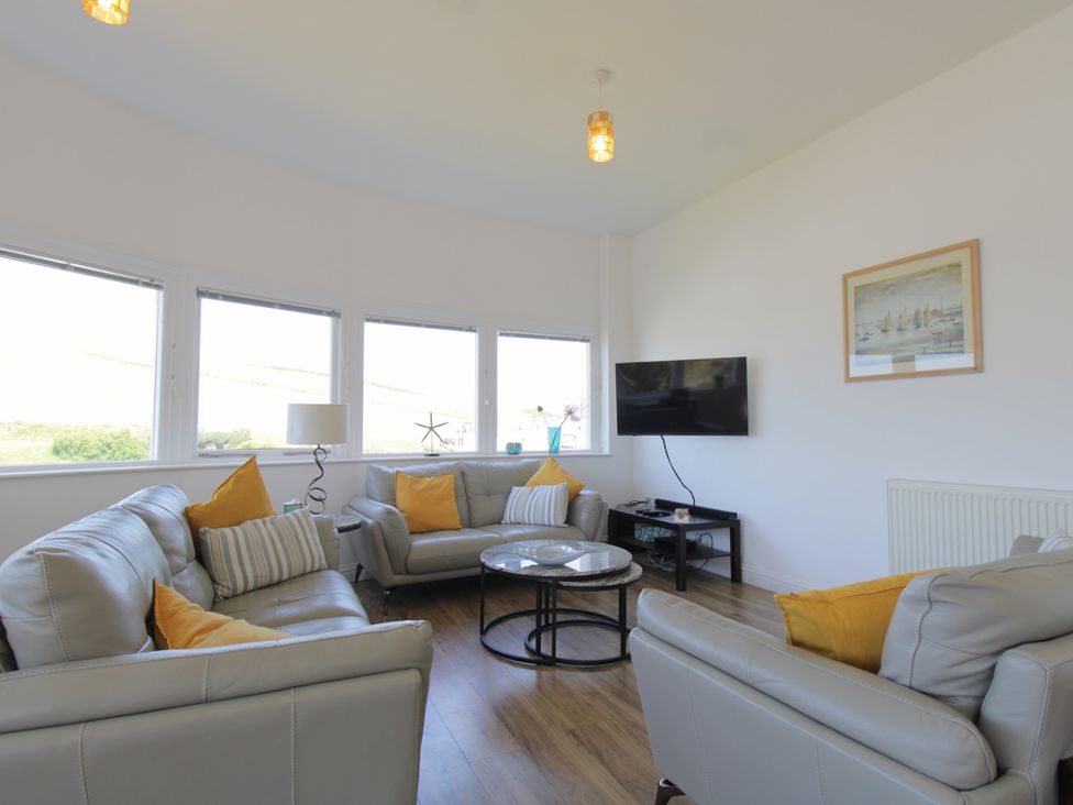 A living room with sofas and a coffee table at 11 Cove View Apartments in Ilfracombe